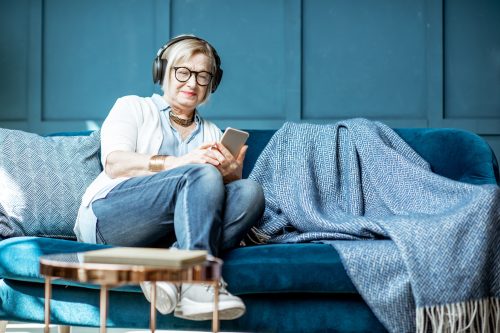 Senior woman listening to the music at home